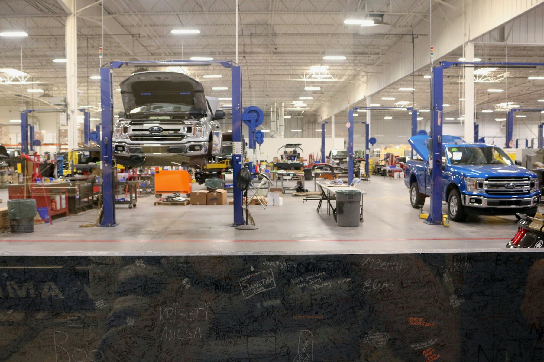 An automotive training workshop with vehicles on ramps
